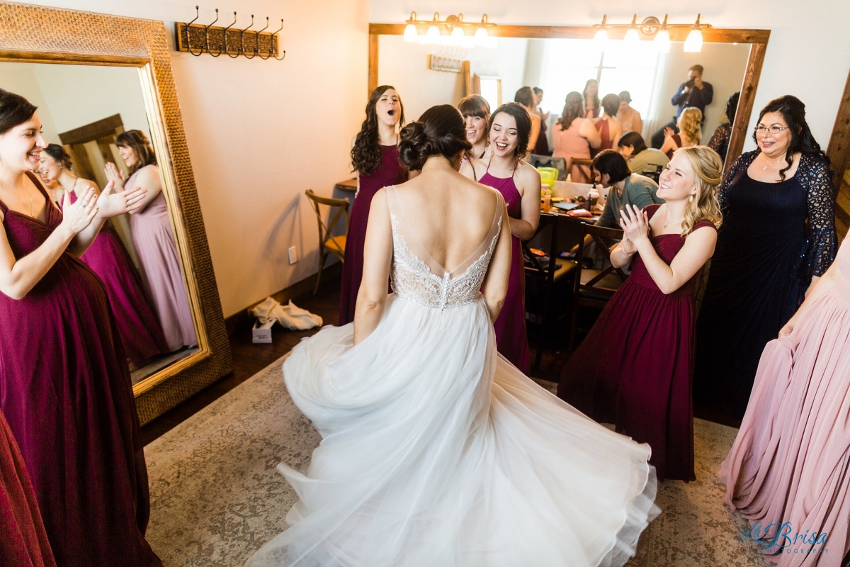 bride twirling in front of bridesmaids at stone crest