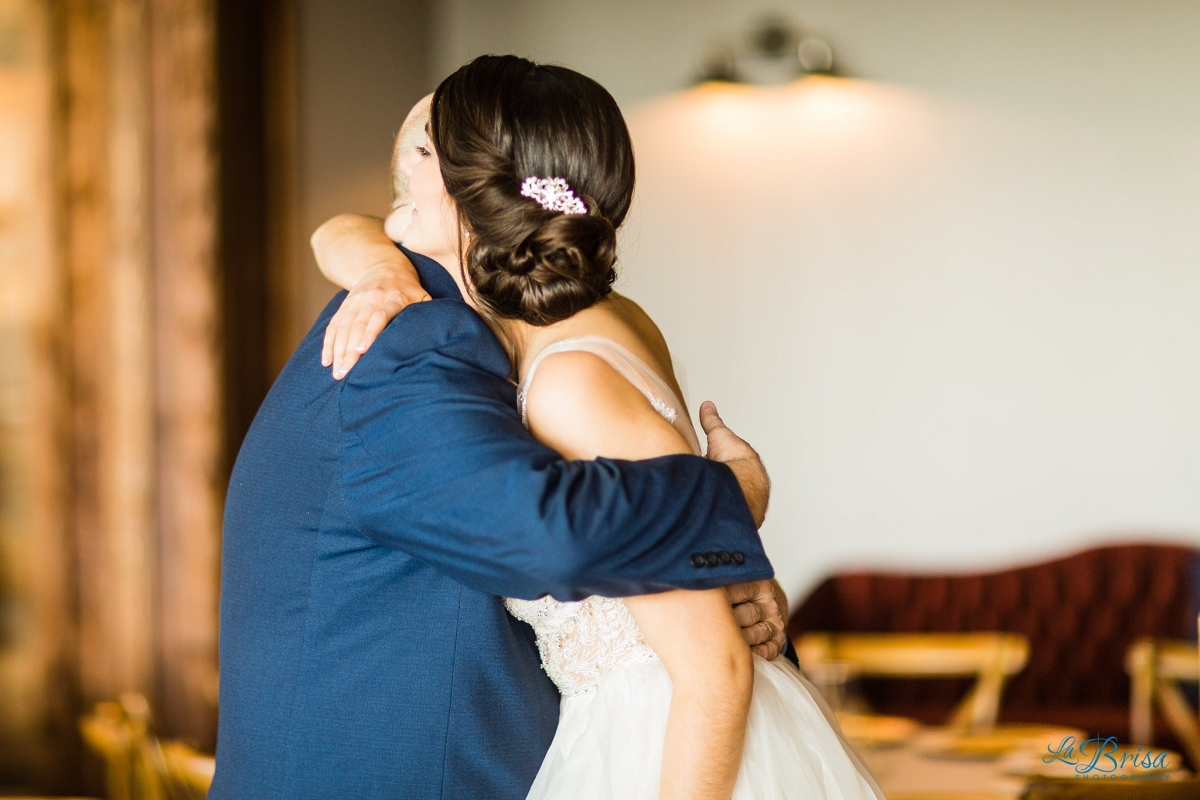 father of bride hugging daughter stone crest