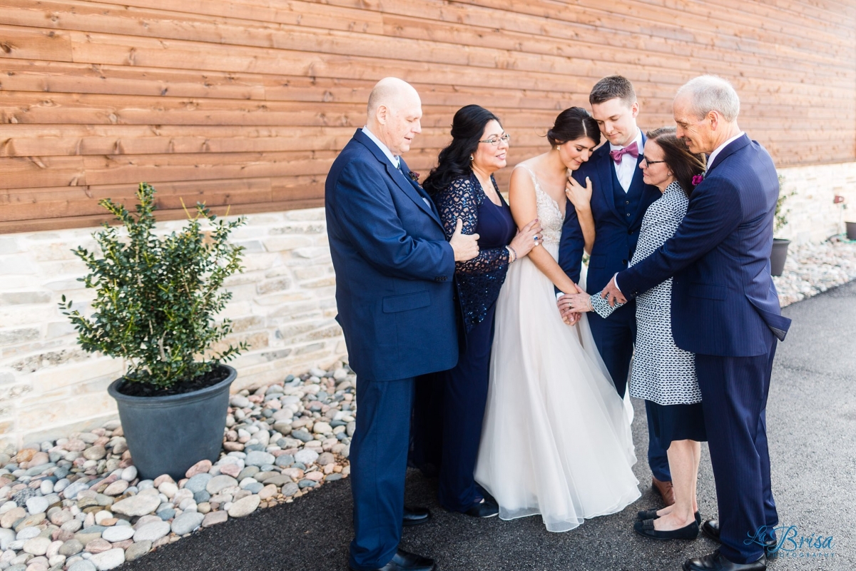 parents of bride and groom praying with bride groom stone crest