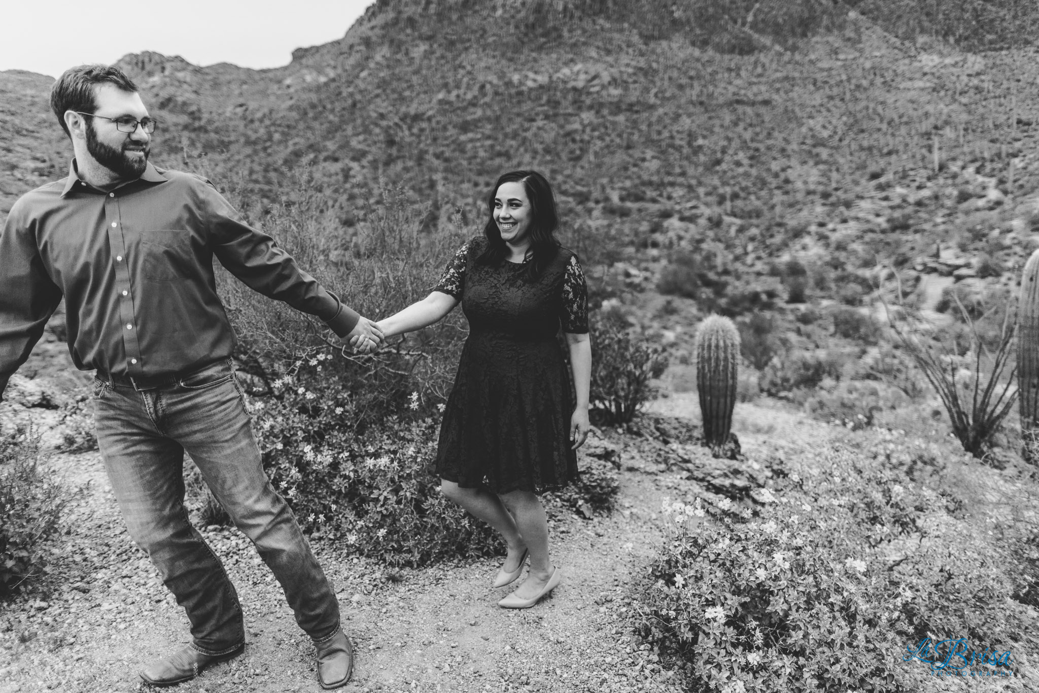 hiking through cactus Gates Pass engagement