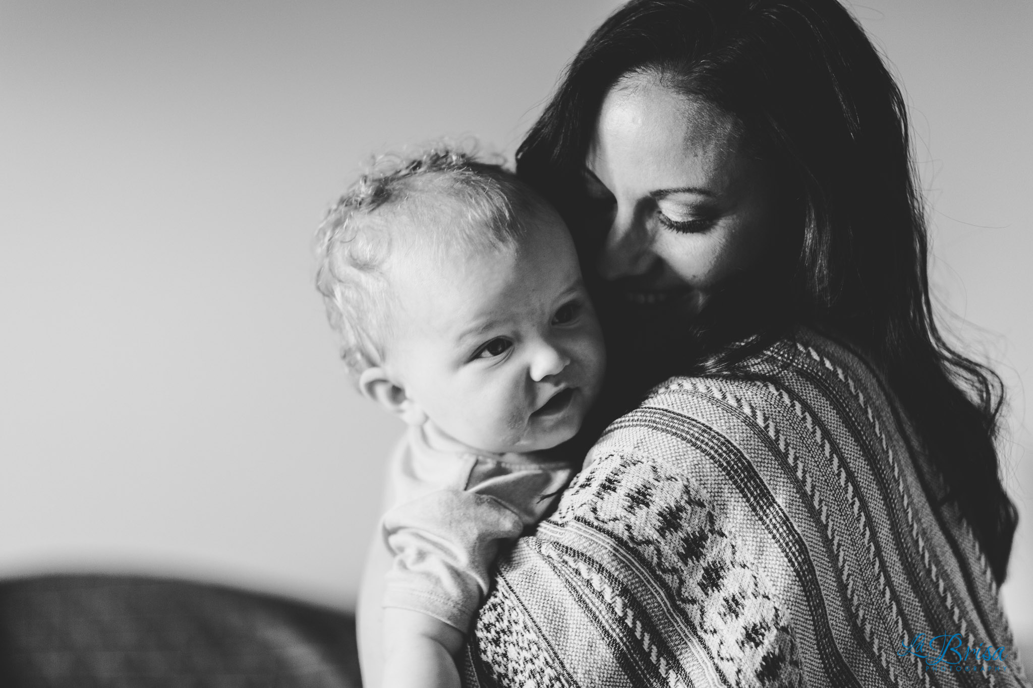 mother son cuddling indoors