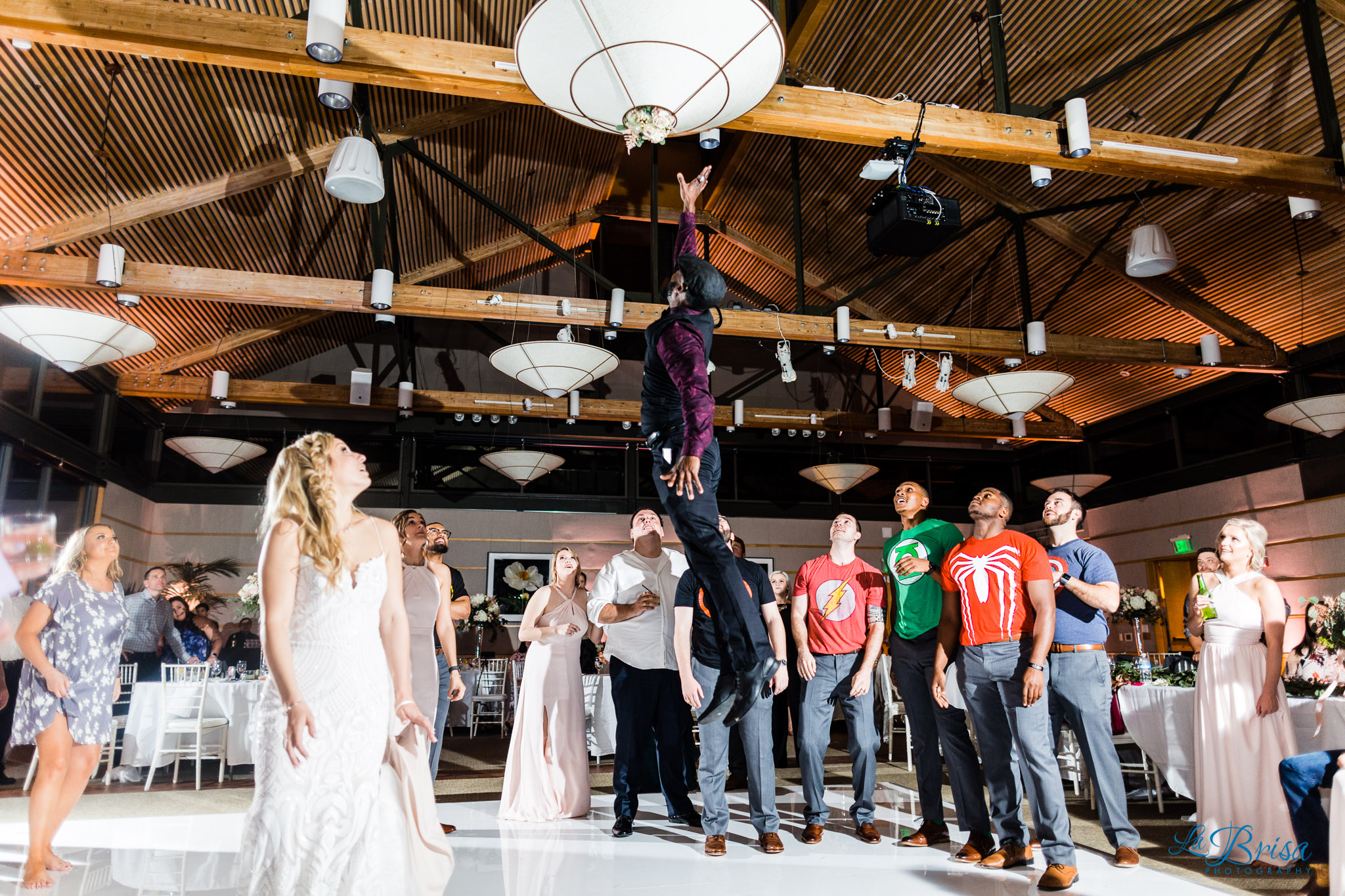 bouquet toss stuck in light dallas arboretum and botanical gardens wedding reception