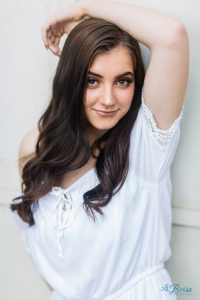 arm over head white dress senior portrait