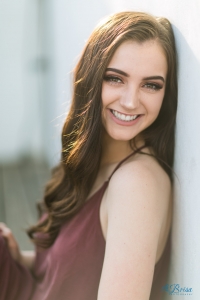 sitting against wall senior portrait pose